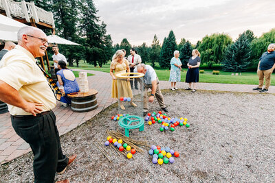 Guests playing games at outdoor wedding reception at The Barn at Finley Point