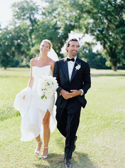 Agapae Oaks wedding bride and groom smiling after recessional. Charleston Bride Weddings. Charleston destination wedding photographer.