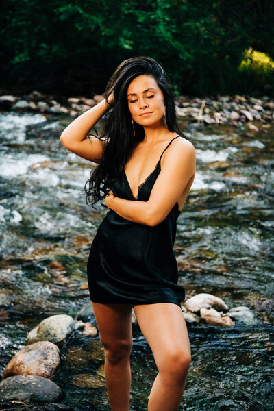 Boudoir outdoors woman in black nighty standing in Rattlesnake Creek, Missoula