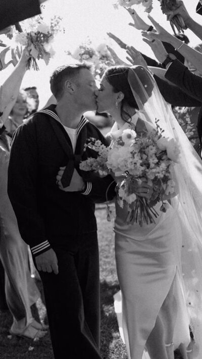 couple kissing as they walk down the isle