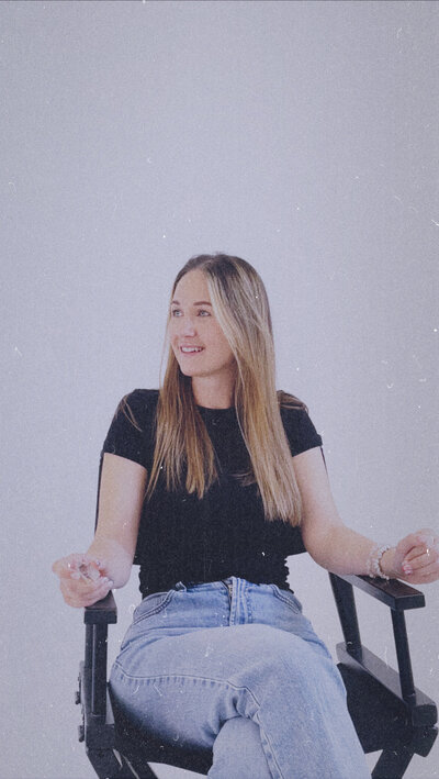 Women sat in a chair smiling in a candid shot