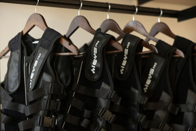 High-tech EMS suits neatly hung, showcasing the cutting-edge technology used in Synergy EMS training sessions