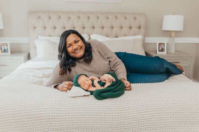 baby girl with a pouty lip sleeping in a floral bucket newborn photoshoot