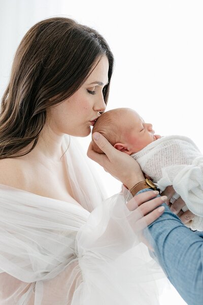 light and airy portrait of a mom holding her newborn baby