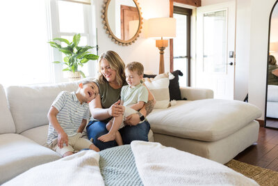 Family sitting on the couch after their living room was professionally cleaned.