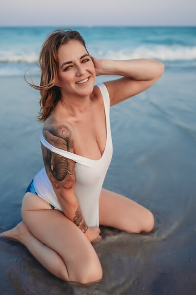woman in a boudoir photoshoot on a beach
