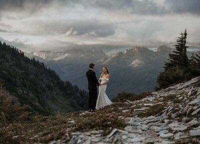An elopement couple holding hands at artist point in North Cascades National Park in Washington.