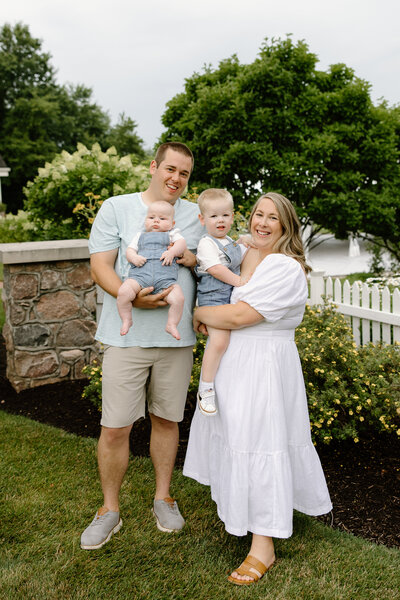 Family of three holding hands and walking away from the camera during Fishers family photos