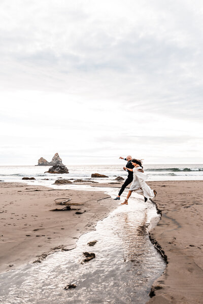 couple kissing on a cliff overlooking the ocean