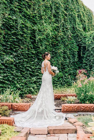 Bride stands in front of Ivy wall at Lucile's Old Market