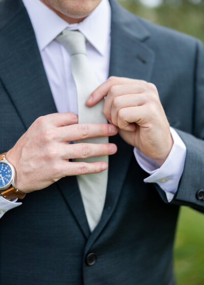 candid photo of groom getting ready at White Birch Barn