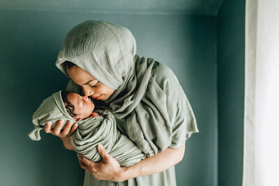 Newborn photoshoot with mom holding her newborn baby.