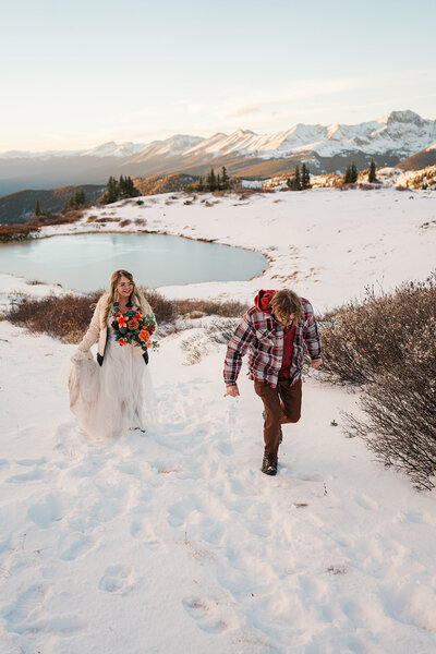 A couple walks in the snow on Cottonwood Pass