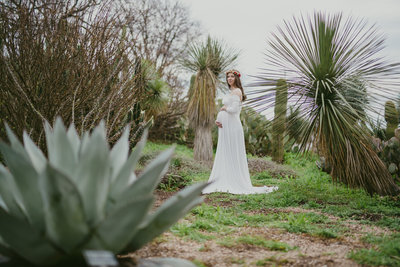 woman in white boho maternity dress surrounded by succulents at San Antonio Botanical Garden by Expose The Heart Photography