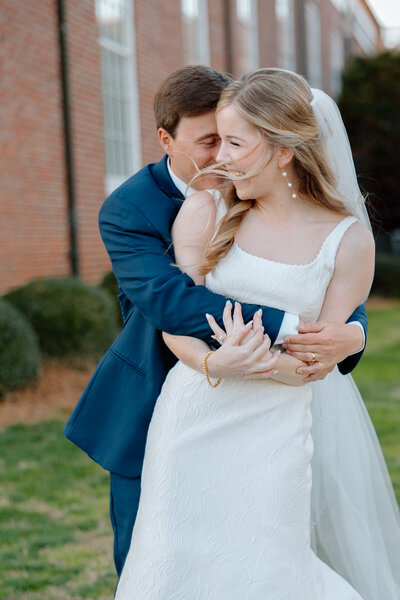 Bride and Groom cuddle and laugh after finishing their ceremony