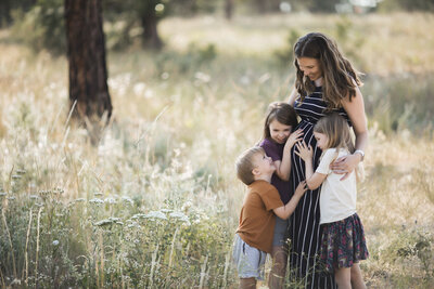 Family playing and smiling in beautiful Seattle sunlight at sunset