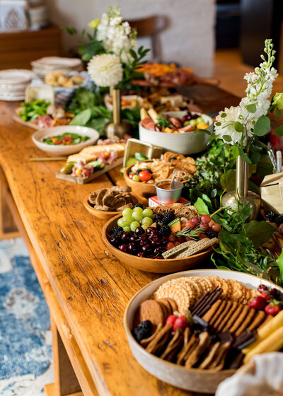 Food lined up on wooden table at Halifax wedding by Anemone Dining