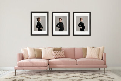 living  room   with   elegant pink  couch  with three framed  matted  maternity images displayed and hung on the  wall