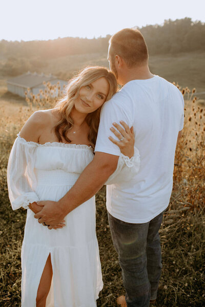 pregnant woman and man standng outside