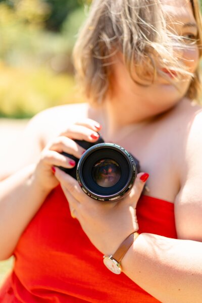 Shannon a wedding photographer holding her camera