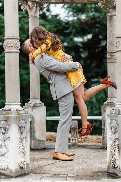 northern VA elopement photograph of a groom holding and kissing his bride at Maymont Park under a stone gazebo