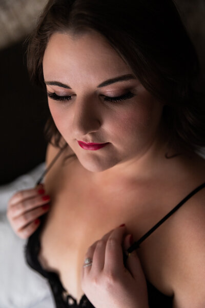 Boudoir photo of Missoula woman in black teddy gazing down