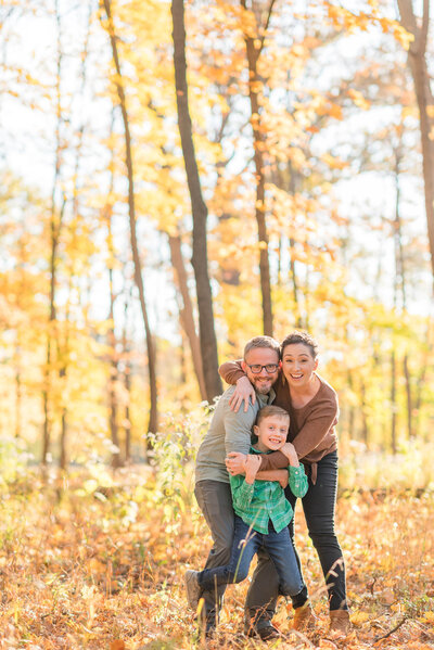 Young girl hugging her mom in a field of yellow grass