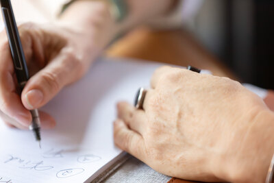 close up of hand with pen writing