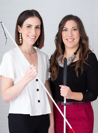 two female consultants standing together holding their walking canes.  Captured in studio by Ottawa Branding Photographer JEMMAN Photography COMMERCIAL