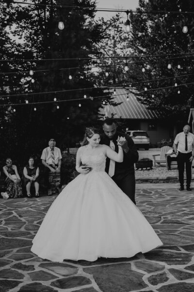Married couple's first dance in an outdoor wedding setup