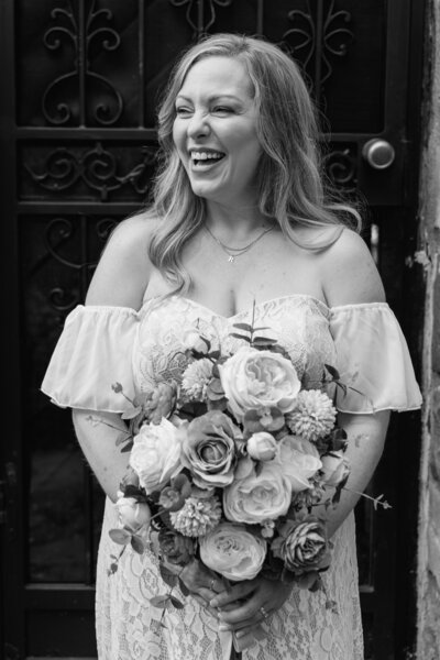 Close-up of an elegant wedding bouquet featuring seasonal flowers, lush greenery, and soft romantic tones, perfect for a timeless bridal look.