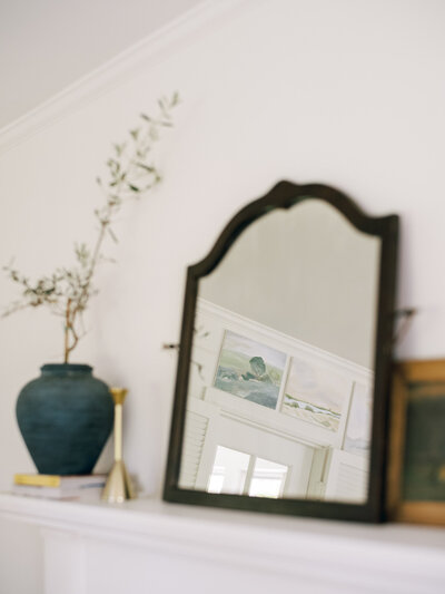 A mirror reflects stunning artwork  from its perch on a mantle. | Brand Photography in Pittsburgh | Anna Laero Photography