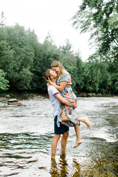 Couple kissing and smiling in river