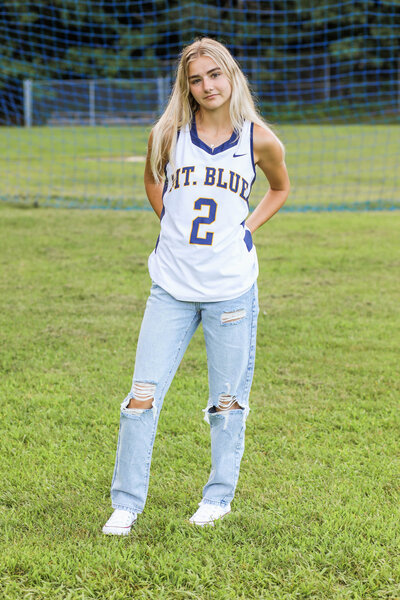 Photo of girl with sport jersey on | Senior Session taken by Maine Photographer
