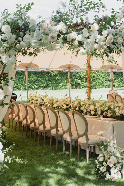 Bride and groom sit on a white couch at Shadowbrook Estate wedding reception