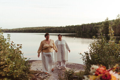 Couple holding hands near water