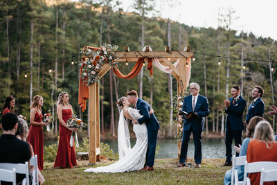 wedding couples first kiss at arbor at pigeon mountain crossing venue in lafayette ga