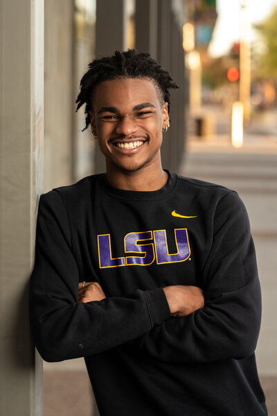 High School Senior Boy with dreadlocks and an LSU sweatshirt