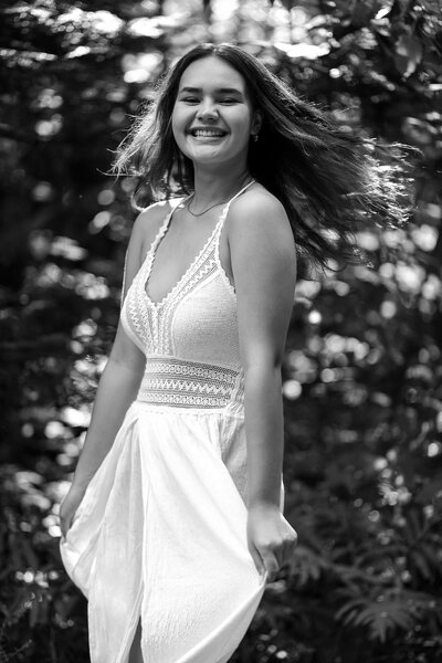 Black & White photo of girl holding dress | Senior Session