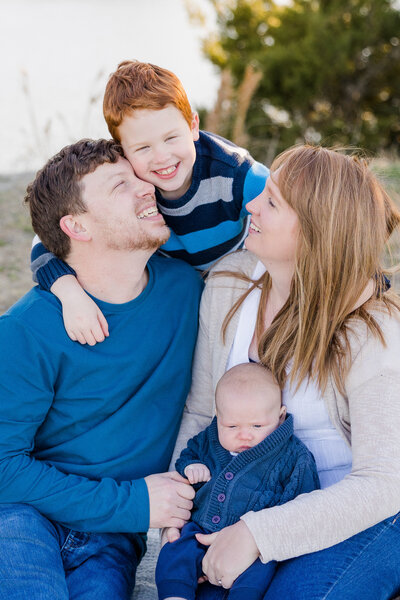 couple hugging their son