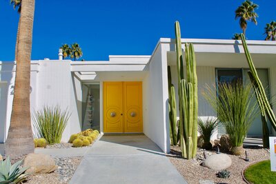 mid century modern house with yellow door