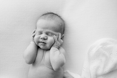 Mom and dad looking down at their newborn baby girl