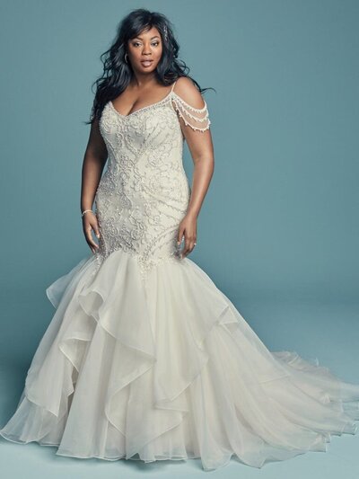 Plus-Size Mermaid Wedding Dress. This plus-size mermaid wedding dress features a little extra coverage along the neckline and back.