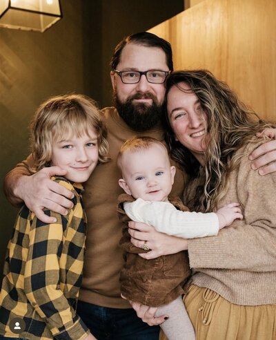 The family behind Grain Artisan Bakery smiling together, symbolizing the transition from a woman-owned small business to a family-run gluten-free bakery in Snohomish, WA.