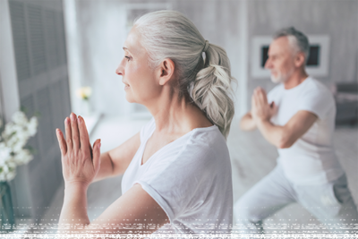 Two people doing yoga with their hands held to heart center