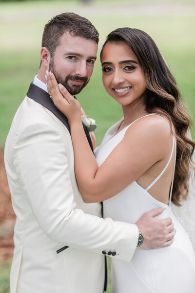 This image is a loving showcase of the bride and groom posing in a classic portraits. 