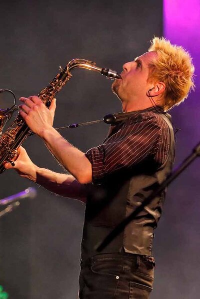 Sax player performing for guests at a party