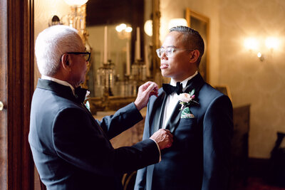 Groom adjusting his suit before the ceremony at his Richmond, VA wedding.