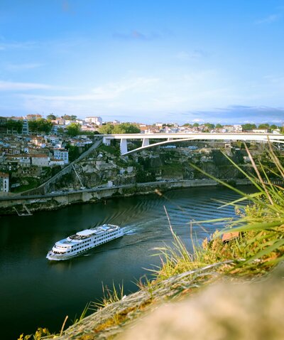 River cruise ship sailing through Porto, Portugal on the scenic Douro River