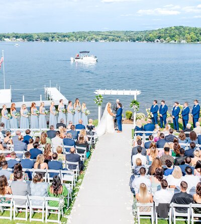 bride and groom say vows during ceremony on lake in glen arbor in northern Michigan wedding